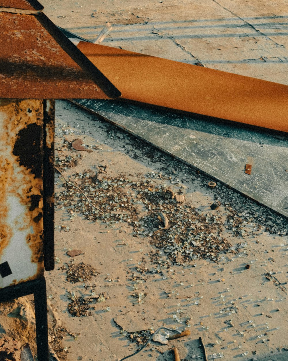 a rusted metal object sitting on top of a sidewalk