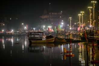 a boat is sitting in the water at night