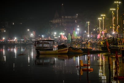 a boat is sitting in the water at night