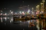 a boat is sitting in the water at night