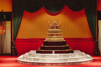 A mystical golden ritual altar glowing softly against a deep black background with ancient ornamental patterns.