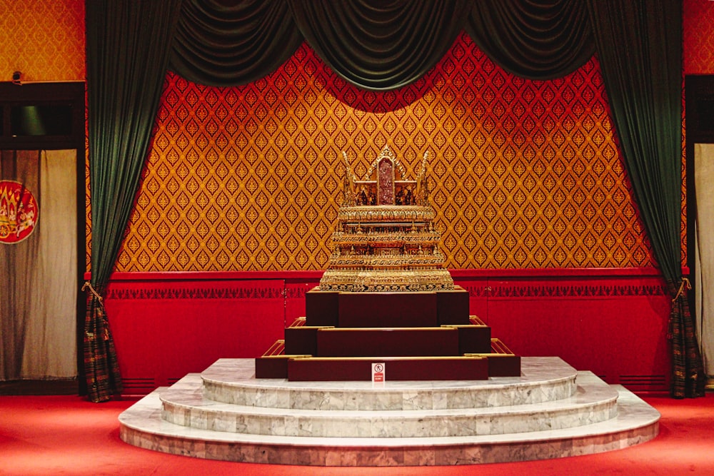 a large golden statue sitting on top of a stage