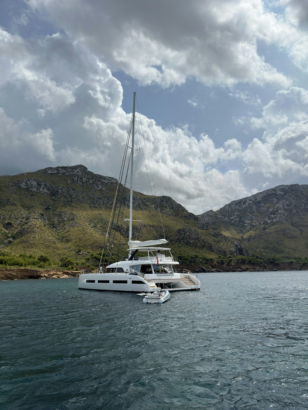 a white boat floating on top of a body of water