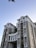 Modern urban residential buildings with clean lines and green spaces under a clear sky.