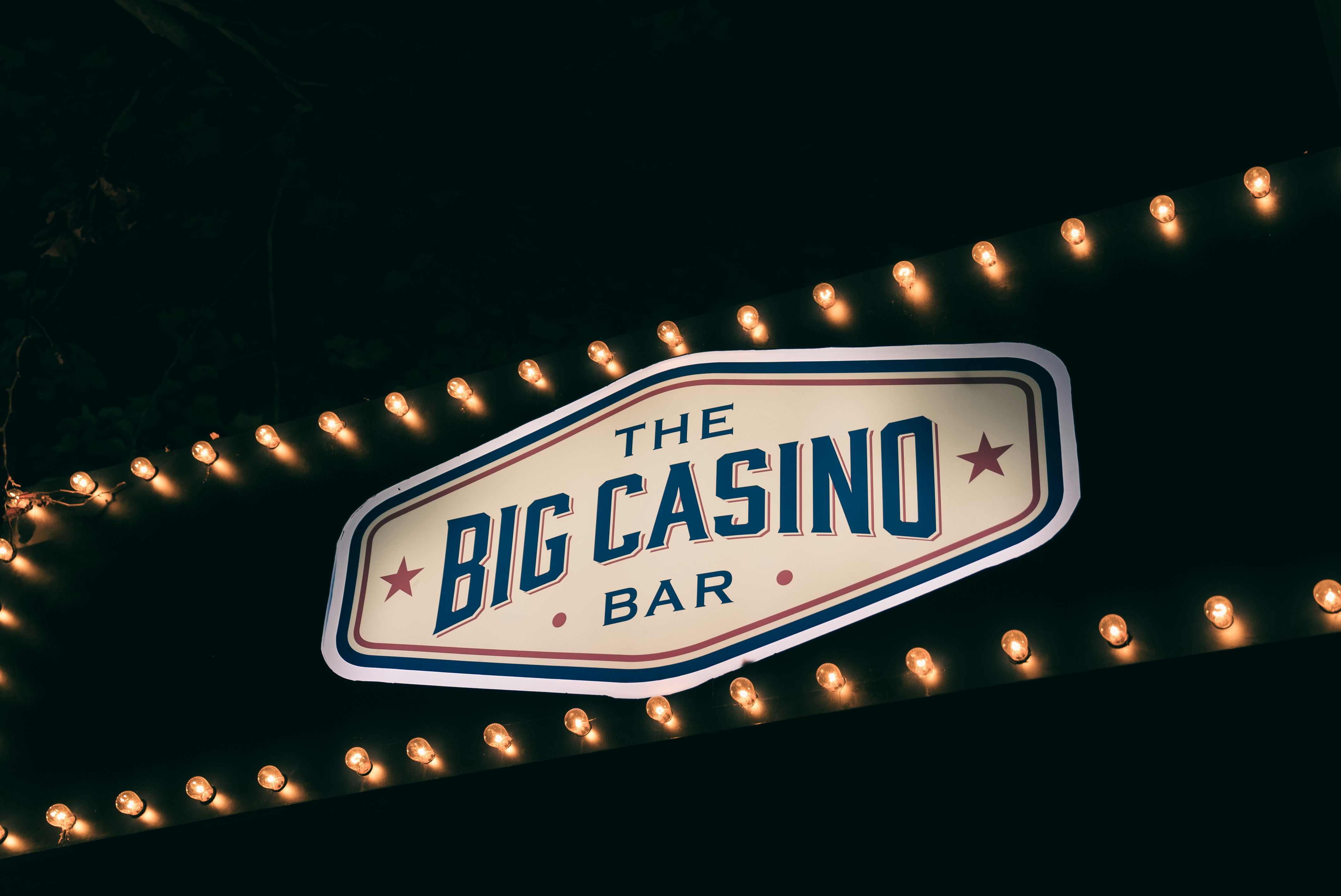 the big casino bar sign is lit up at night