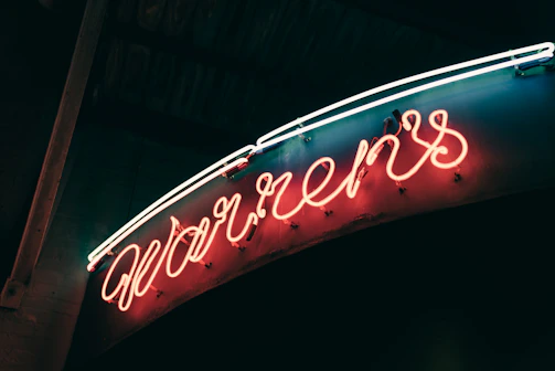Purple neon script sign elegantly highlighting a cozy event setting.