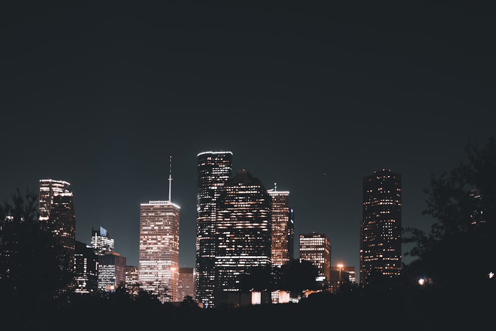 a night view of a city with tall buildings