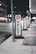 Several valet signs are lined up along a city street at night. The signs are marked with a large red V and the word 'VALET' in bold black letters on a white background. The street is dimly lit, with buildings and streetlights visible in the background.