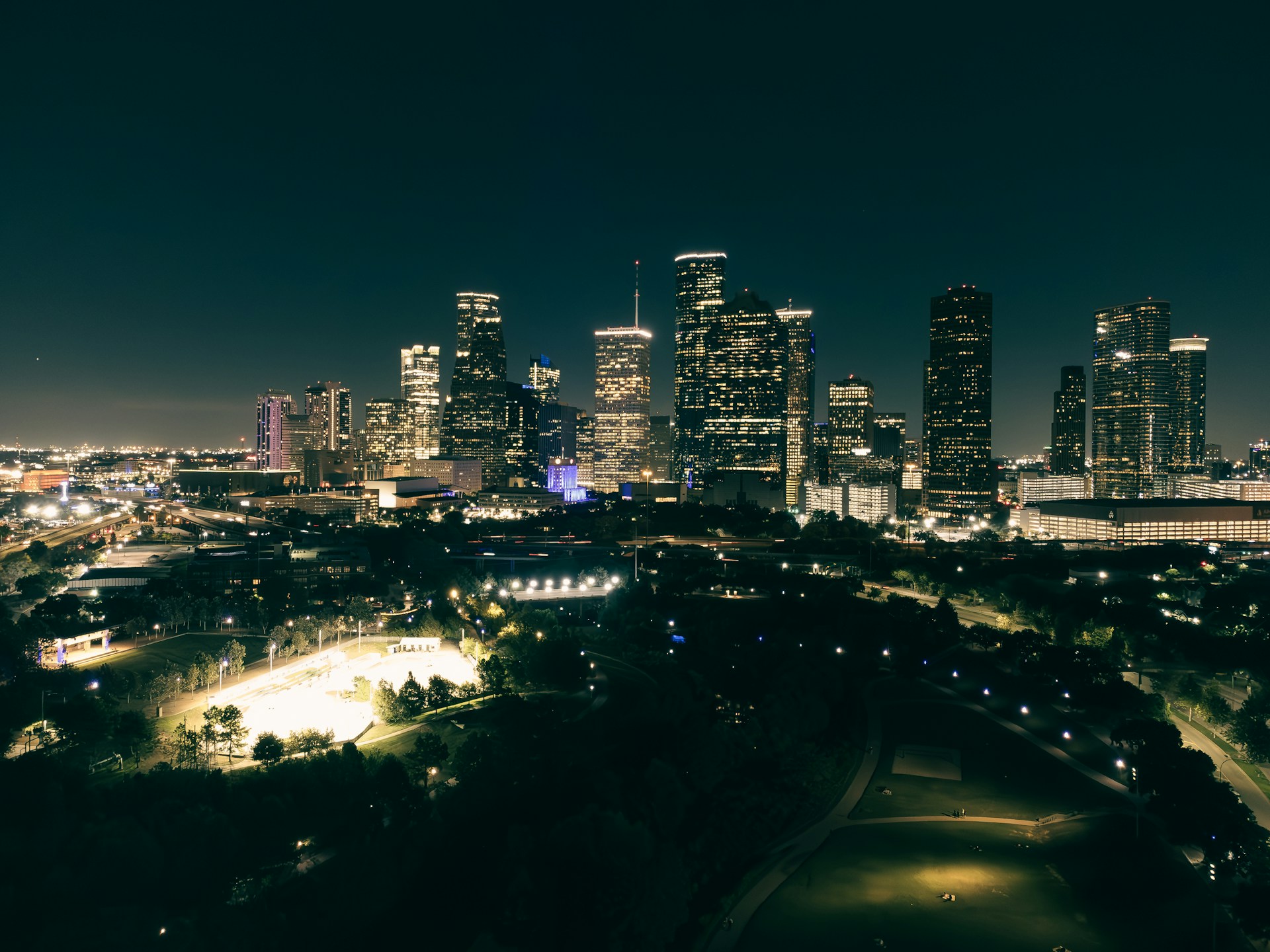a night view of a city with a lot of tall buildings