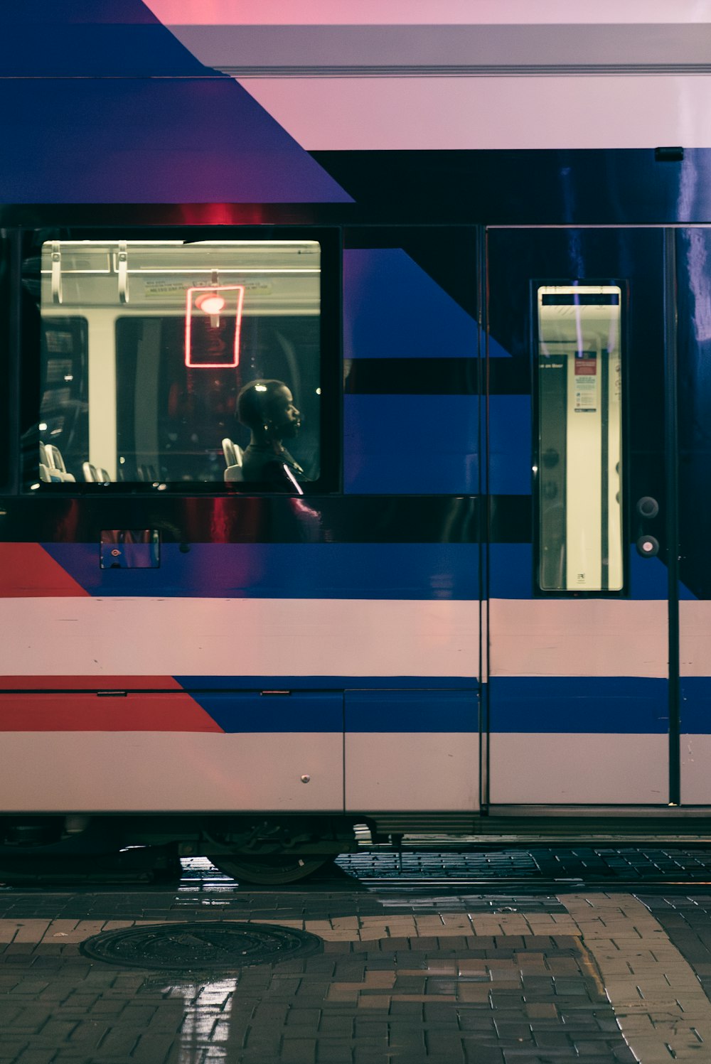 a train with a red, white, and blue stripe on it