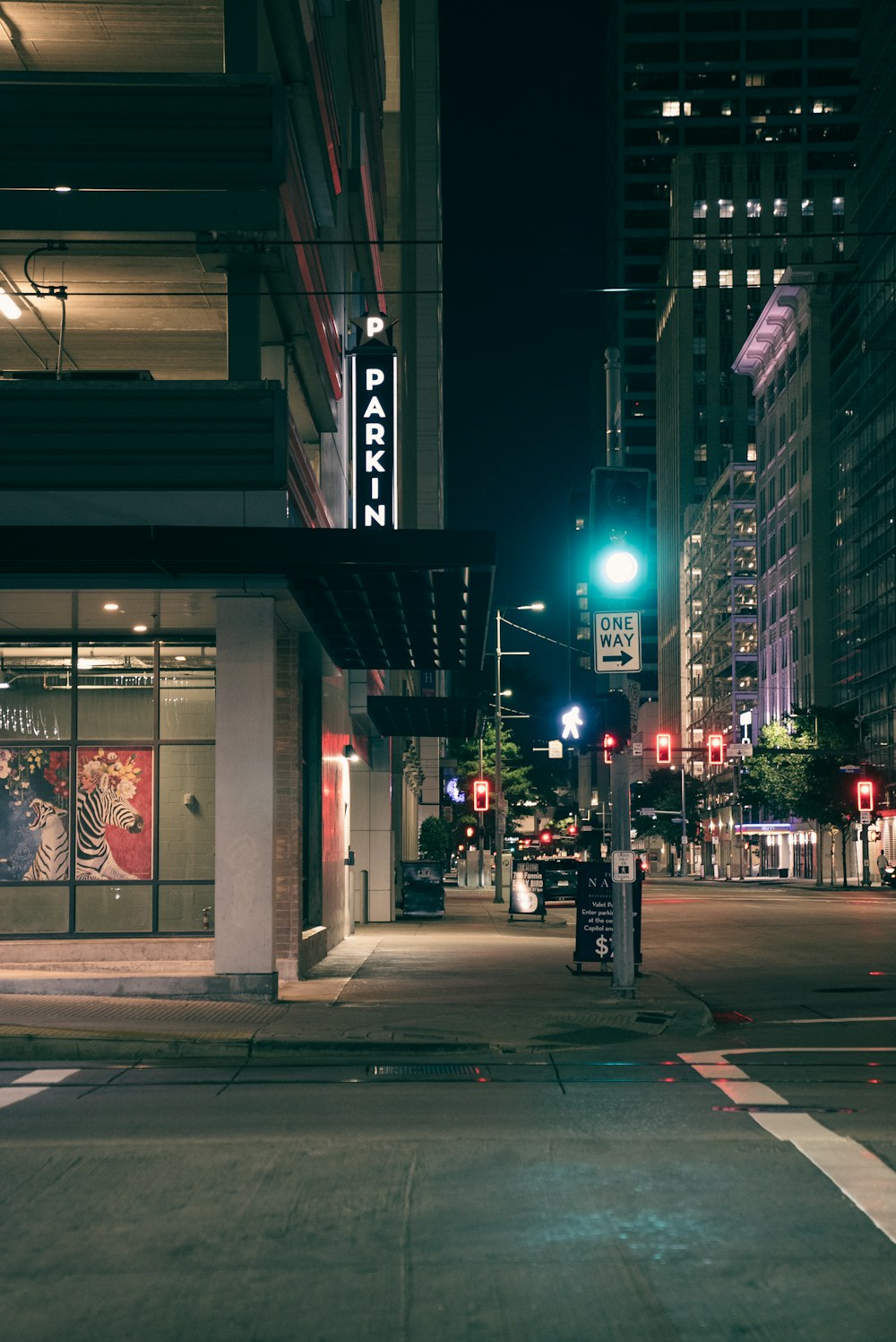 a city street at night with traffic lights