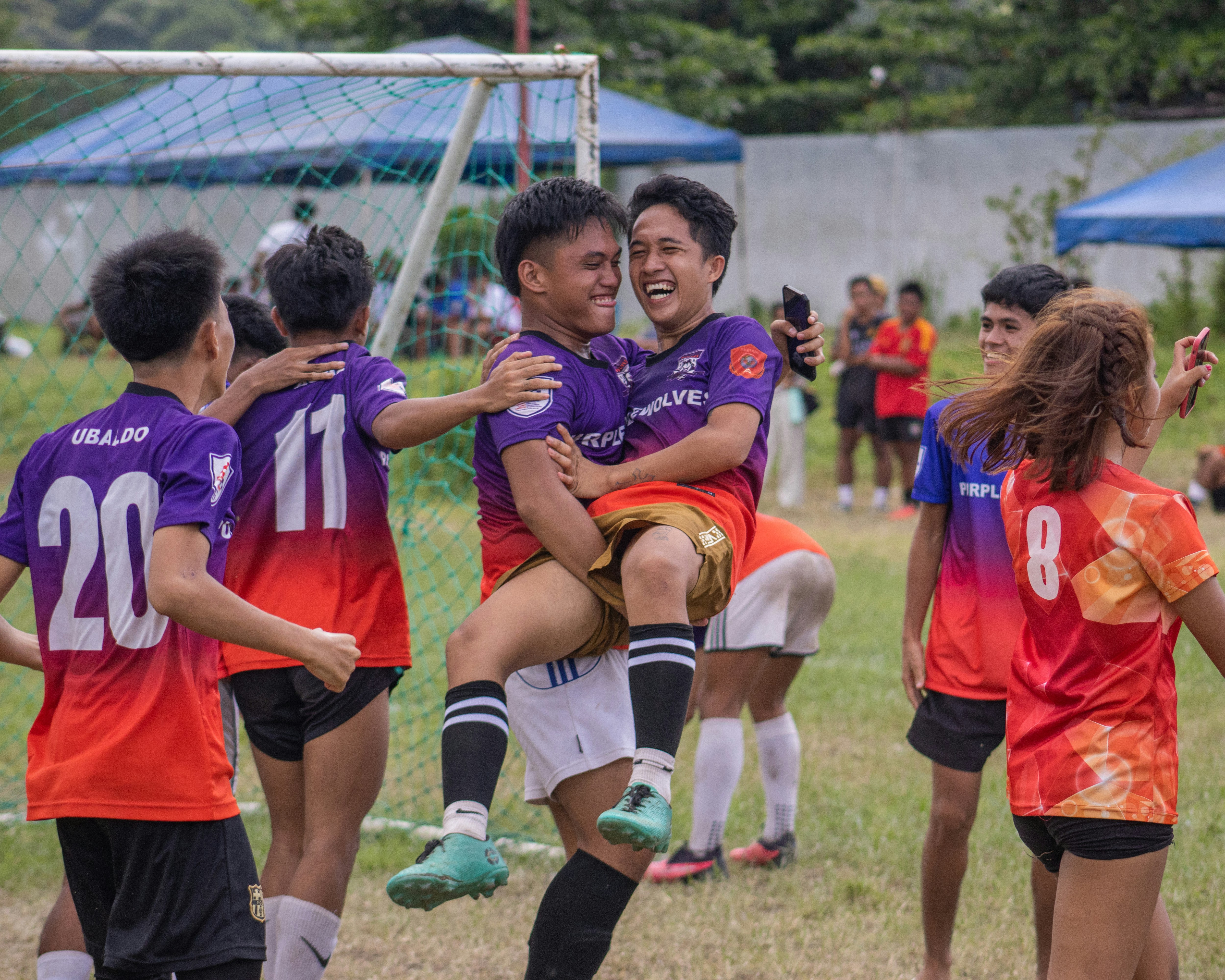 a group of young people playing a game of soccer