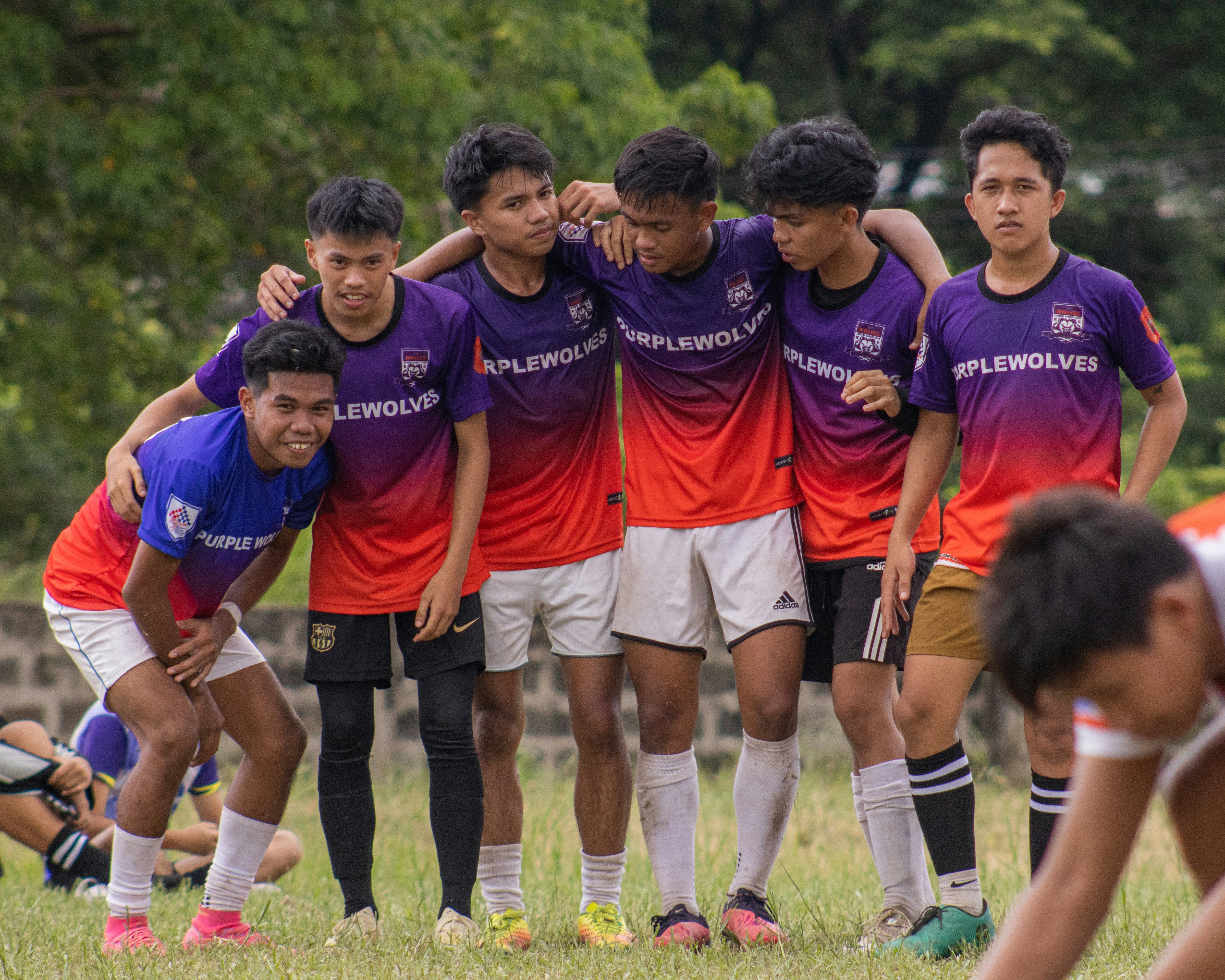 a group of young men standing next to each other on a field