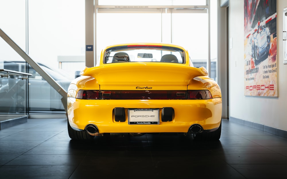 a yellow sports car parked in a building