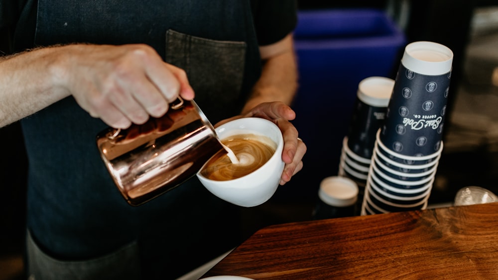 a man pours a cup of coffee