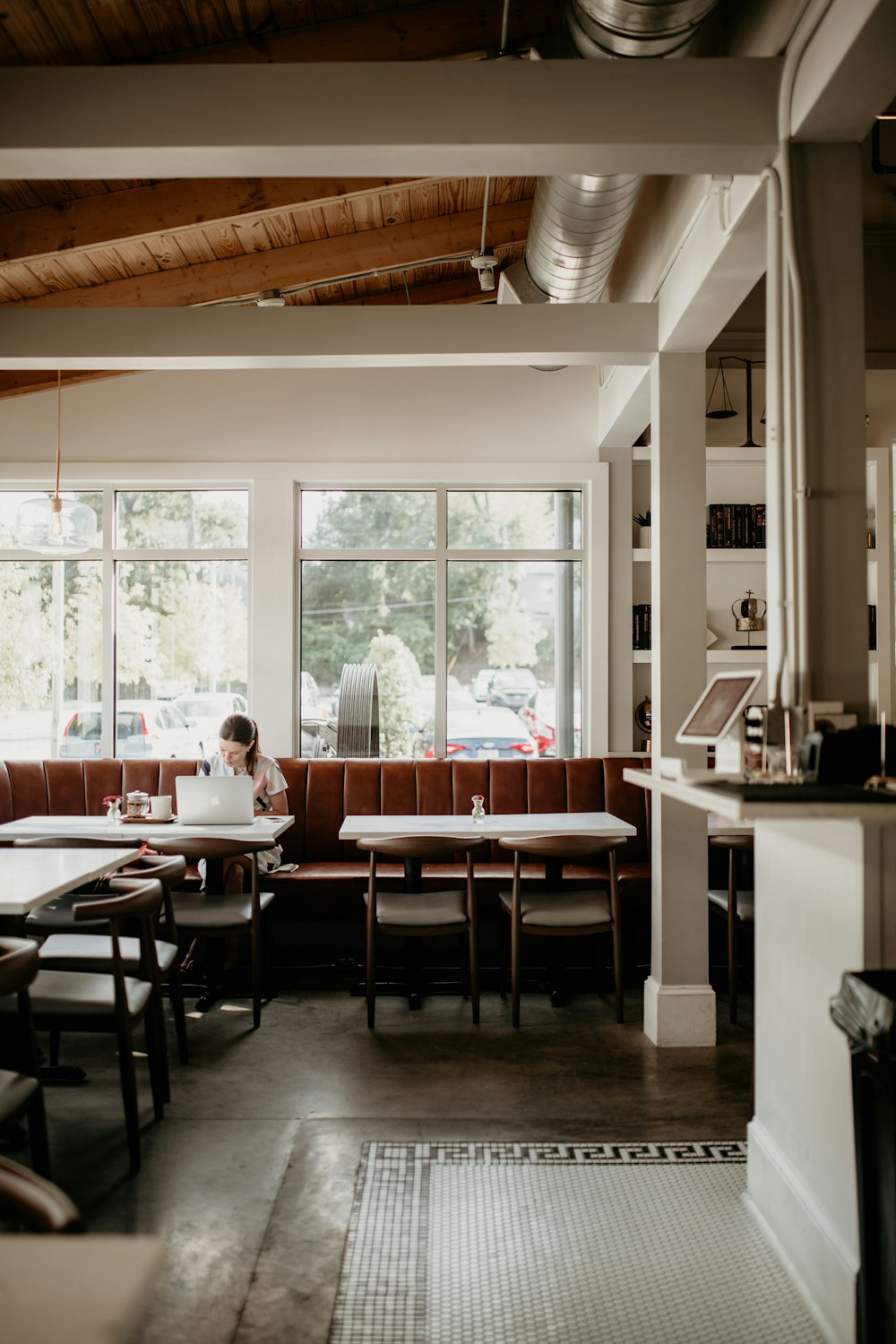 a person sitting at a table in a restaurant