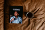 Cover of one of Ed Gordon's published books displayed on a wooden desk with a coffee cup nearby.