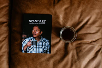 Close-up of a printed African Digital Review magazine laid on a dark wooden desk with a cup of coffee nearby.