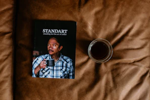 Cover of one of Ed Gordon's published books displayed on a wooden desk with a coffee cup nearby.