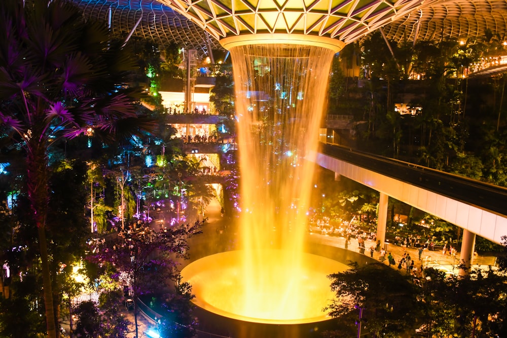 a large fountain in the middle of a city at night