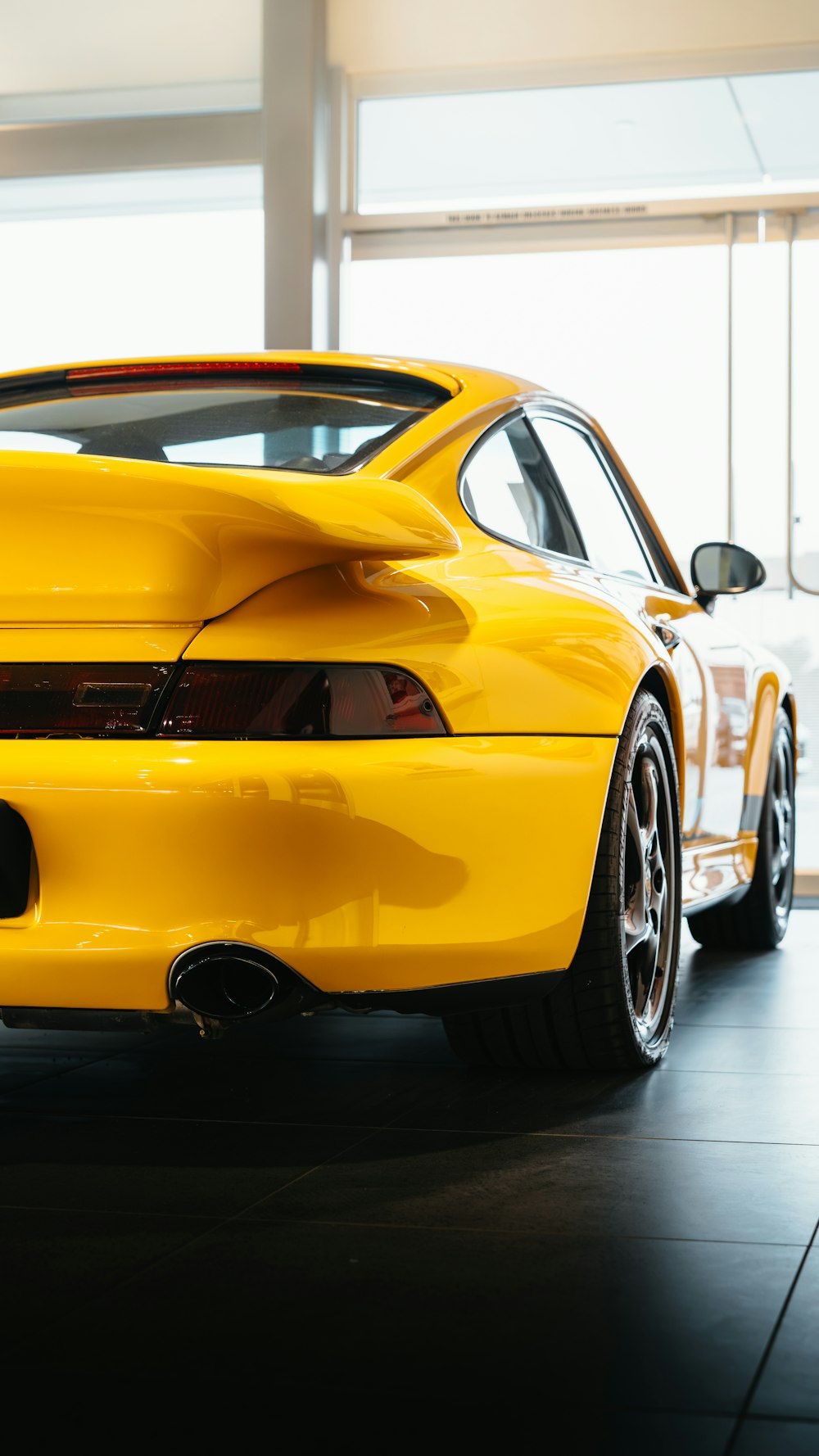 a yellow sports car parked in a garage