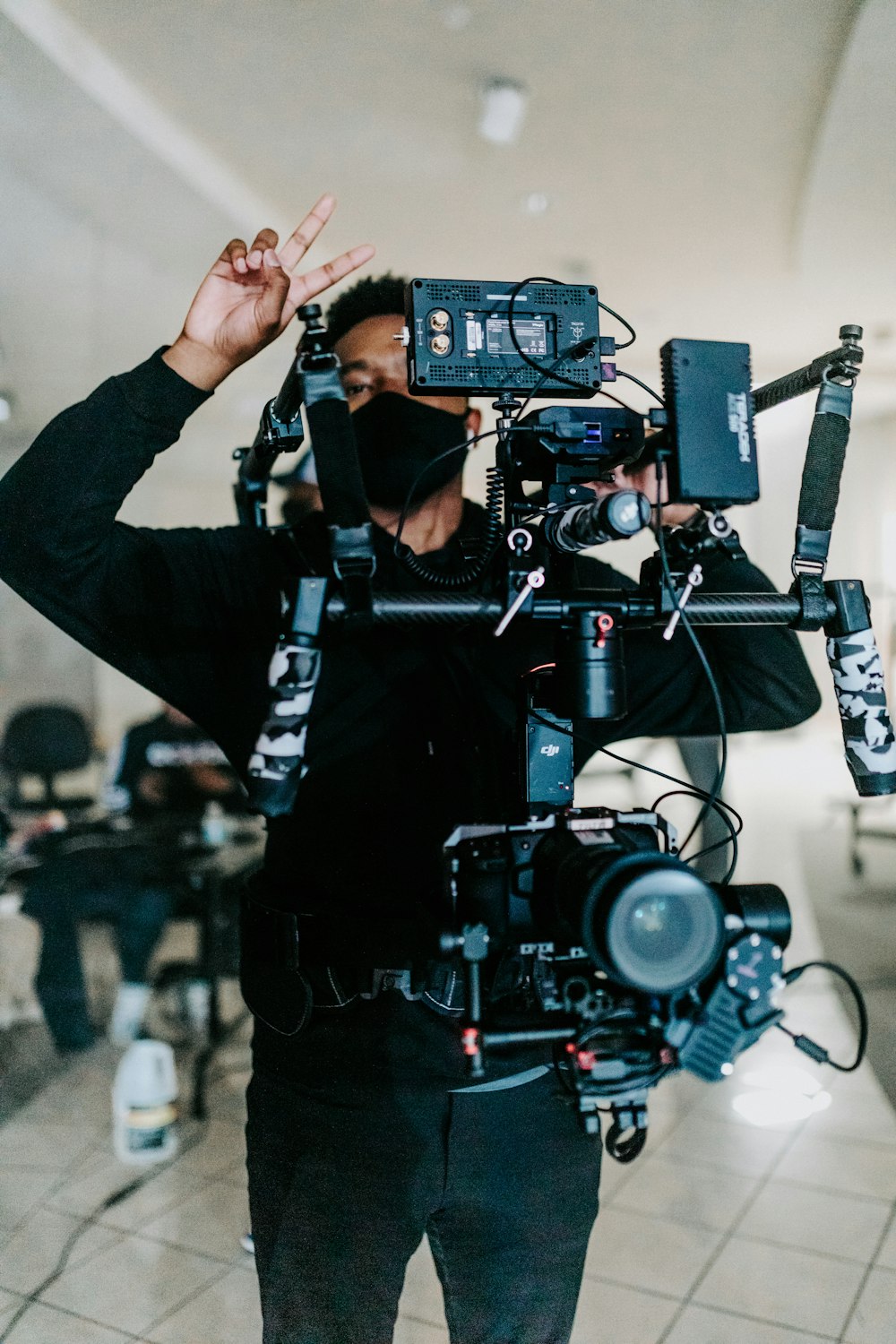 a man in a black shirt holding a camera