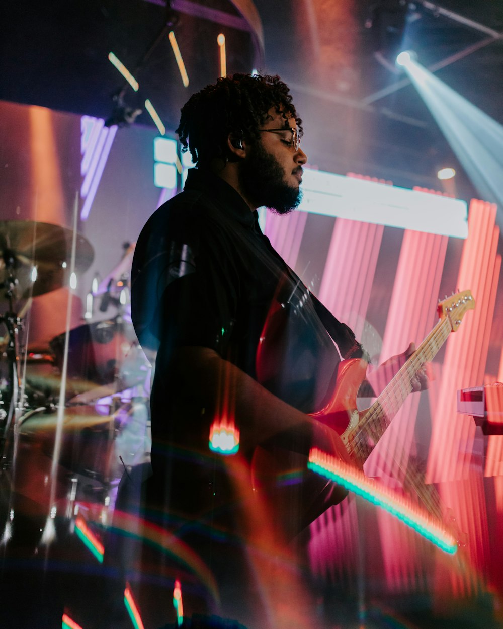 a man playing a guitar on a stage