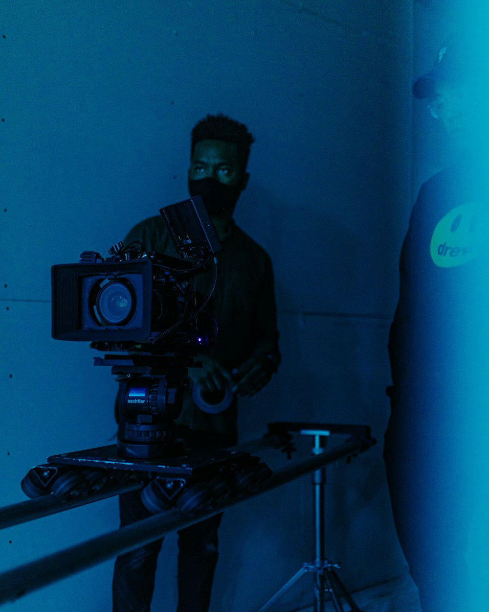 a man holding a camera in a dark room