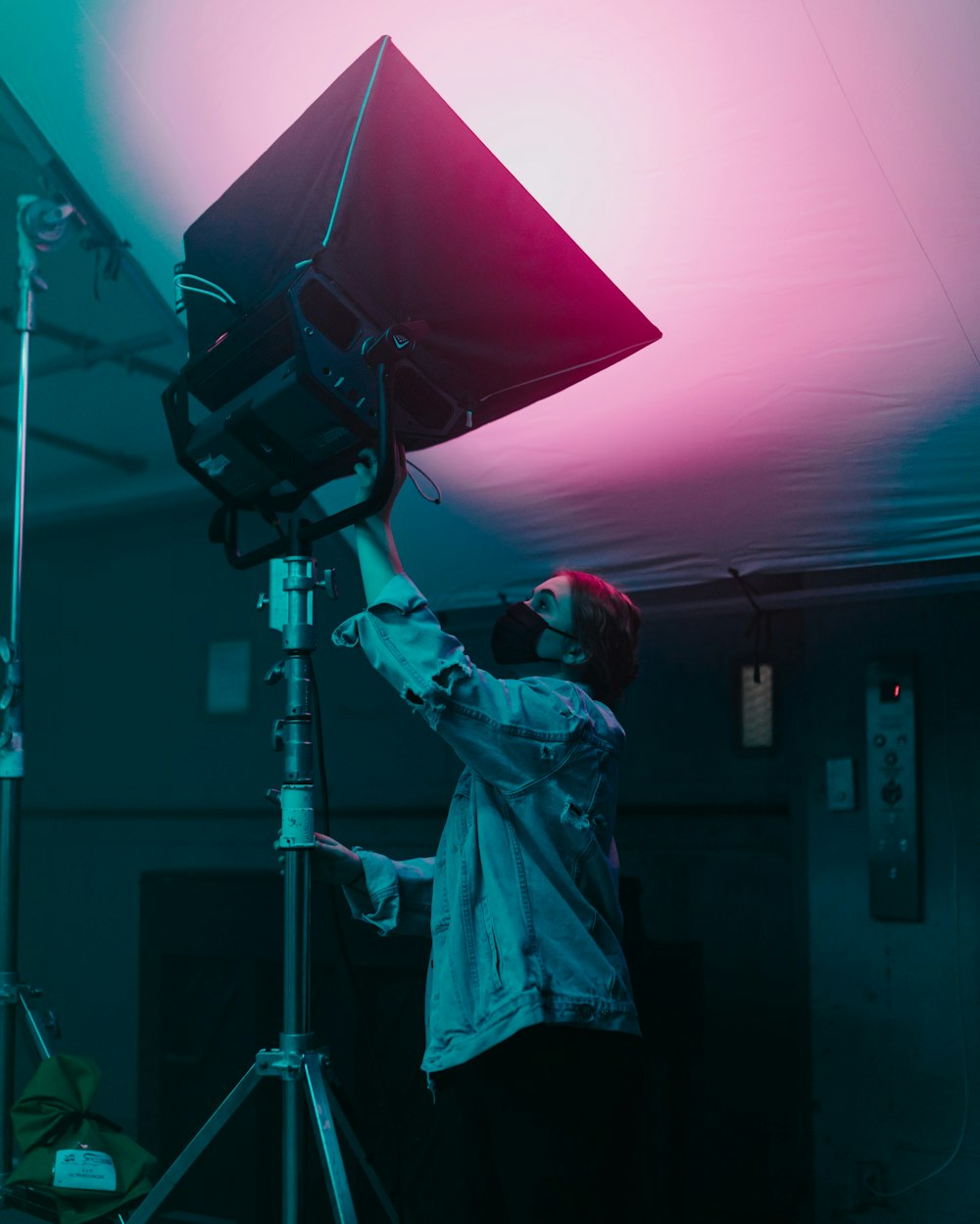 a man standing next to a camera on top of a tripod