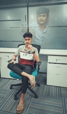 A professional portrait of Pouyan Nassiri in a modern office setting.