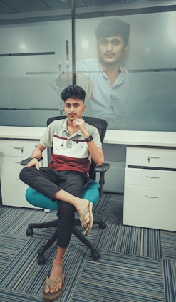 A professional portrait of Pouyan Nassiri in a modern office setting.