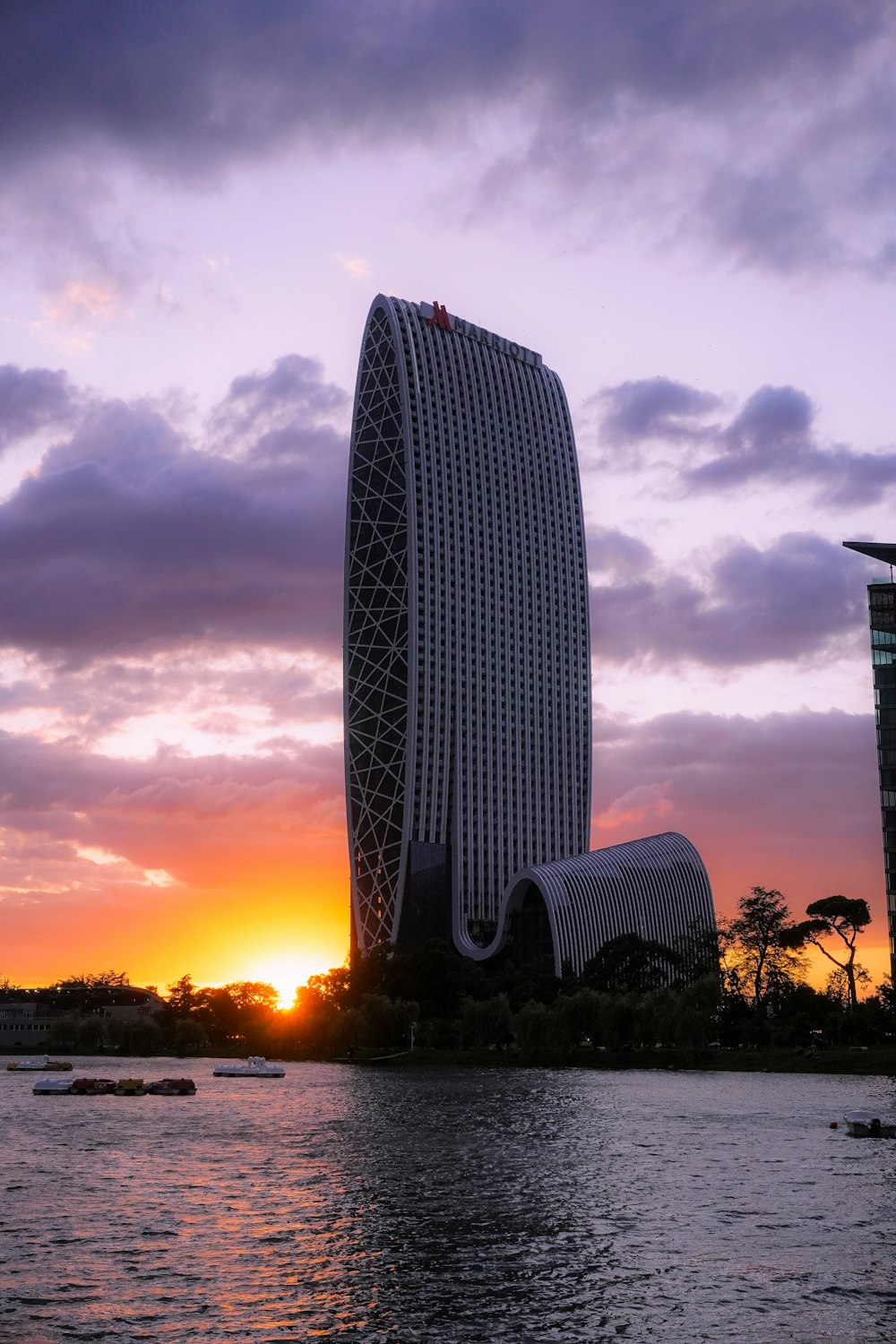 a very tall building sitting next to a body of water