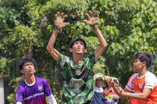 Village youth playing a spirited game during a local sports tournament.