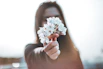a woman holding a flower in her hand