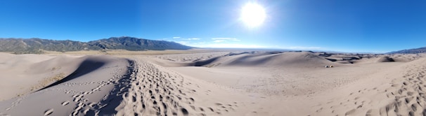 Adventurers trekking through the rocky paths of the Agafay desert under a bright sky.
