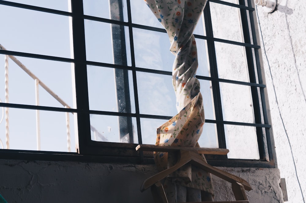 a tie hanging from a window in a building