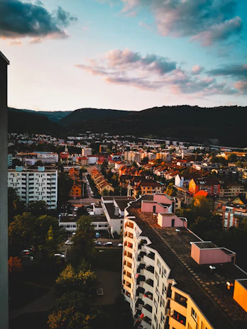 A lively picture capturing the sunset over Pune’s bustling streets from a rooftop.