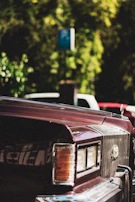 An elegant vintage car front grill with a muted deep brown background.