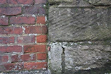 Before and after comparison of a garden wall, showing the difference with and without the barrier.