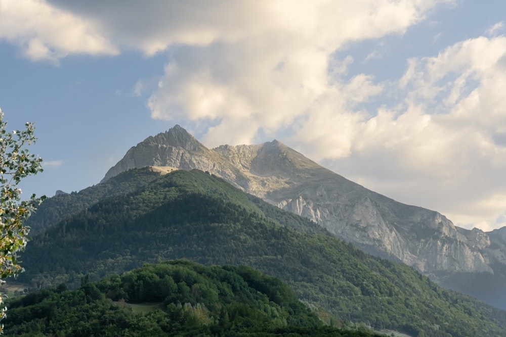 a view of a mountain range with clouds in the sky