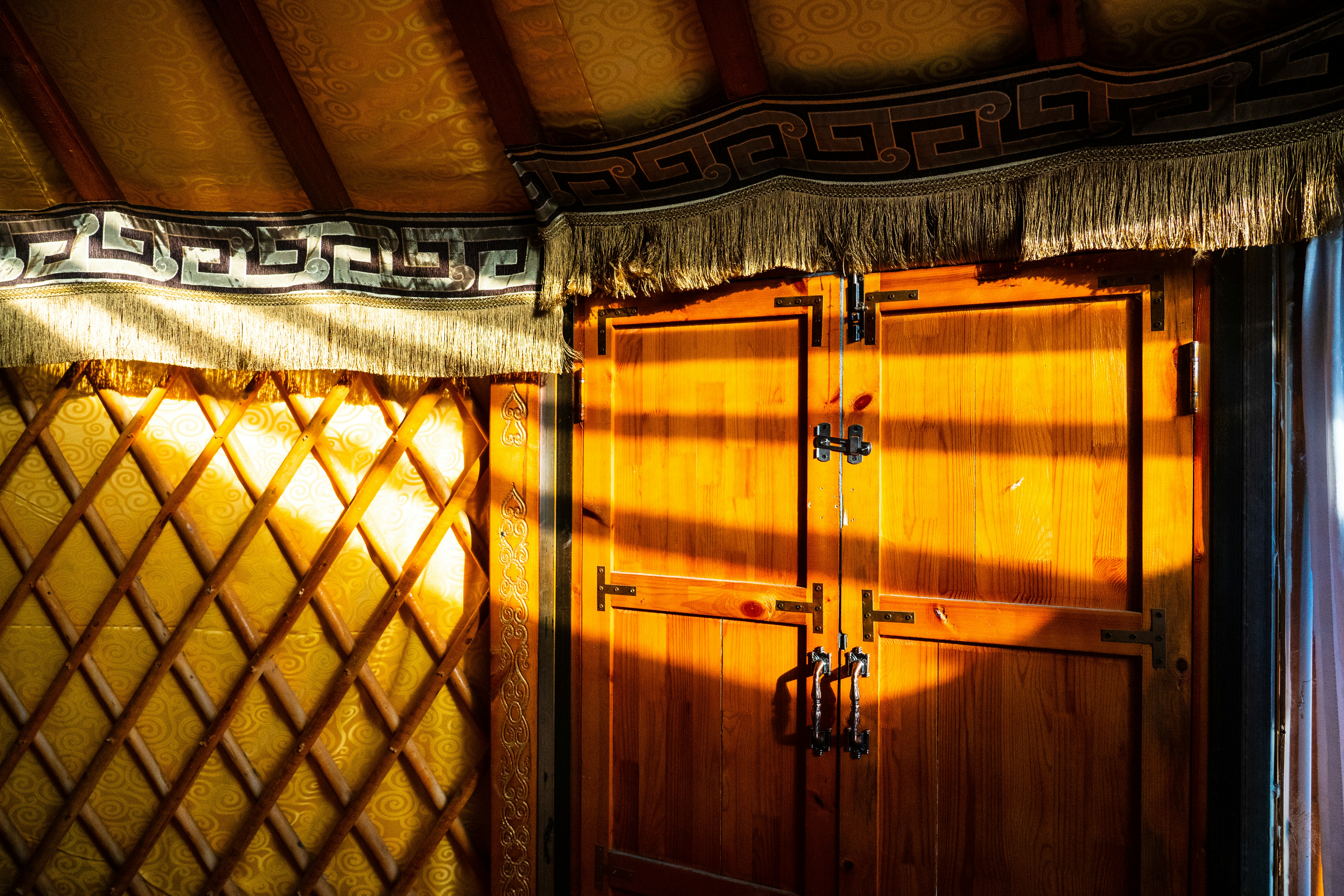 a room with two wooden doors and a window, Inner Mongolia, China