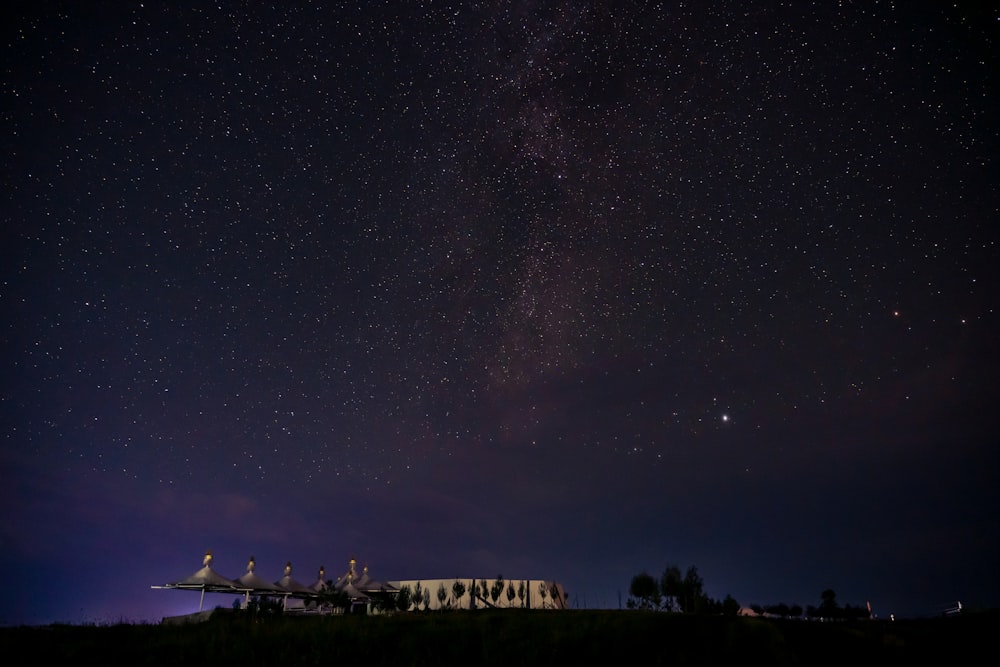 the night sky with stars above a building