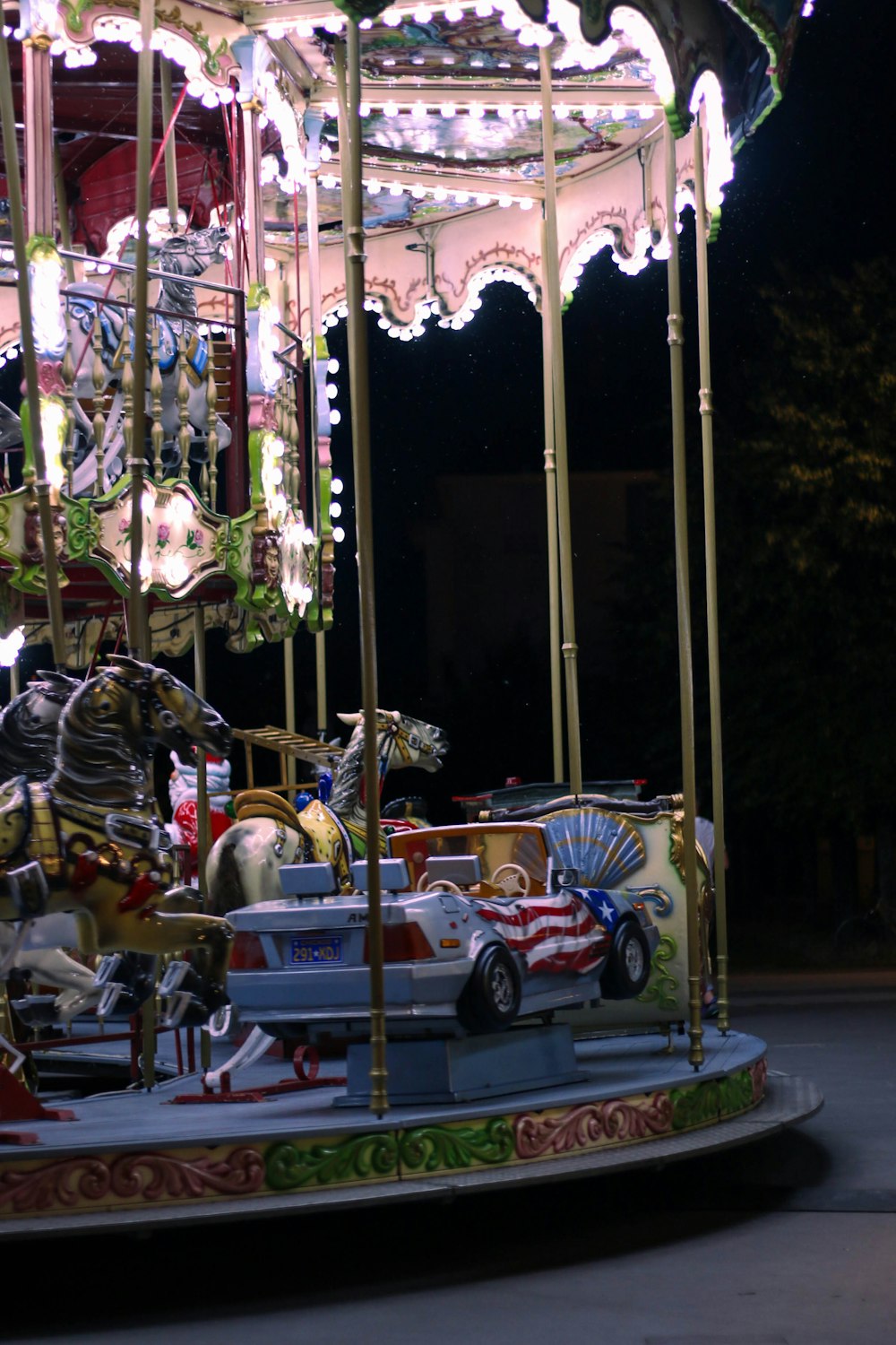 a merry go round at night with lights on