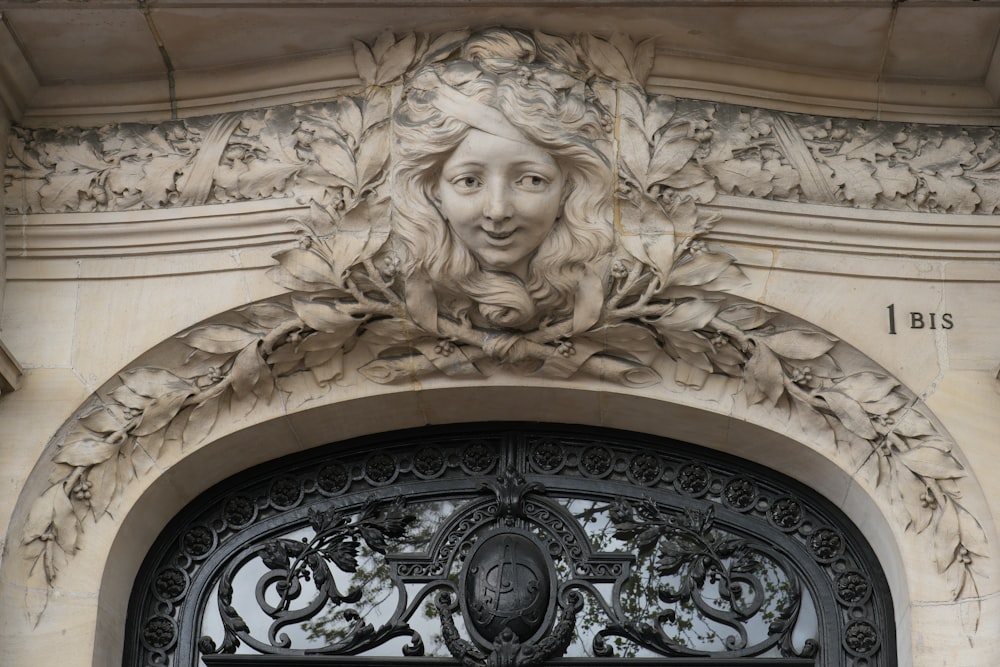 a close up of a metal door with a woman's face on it