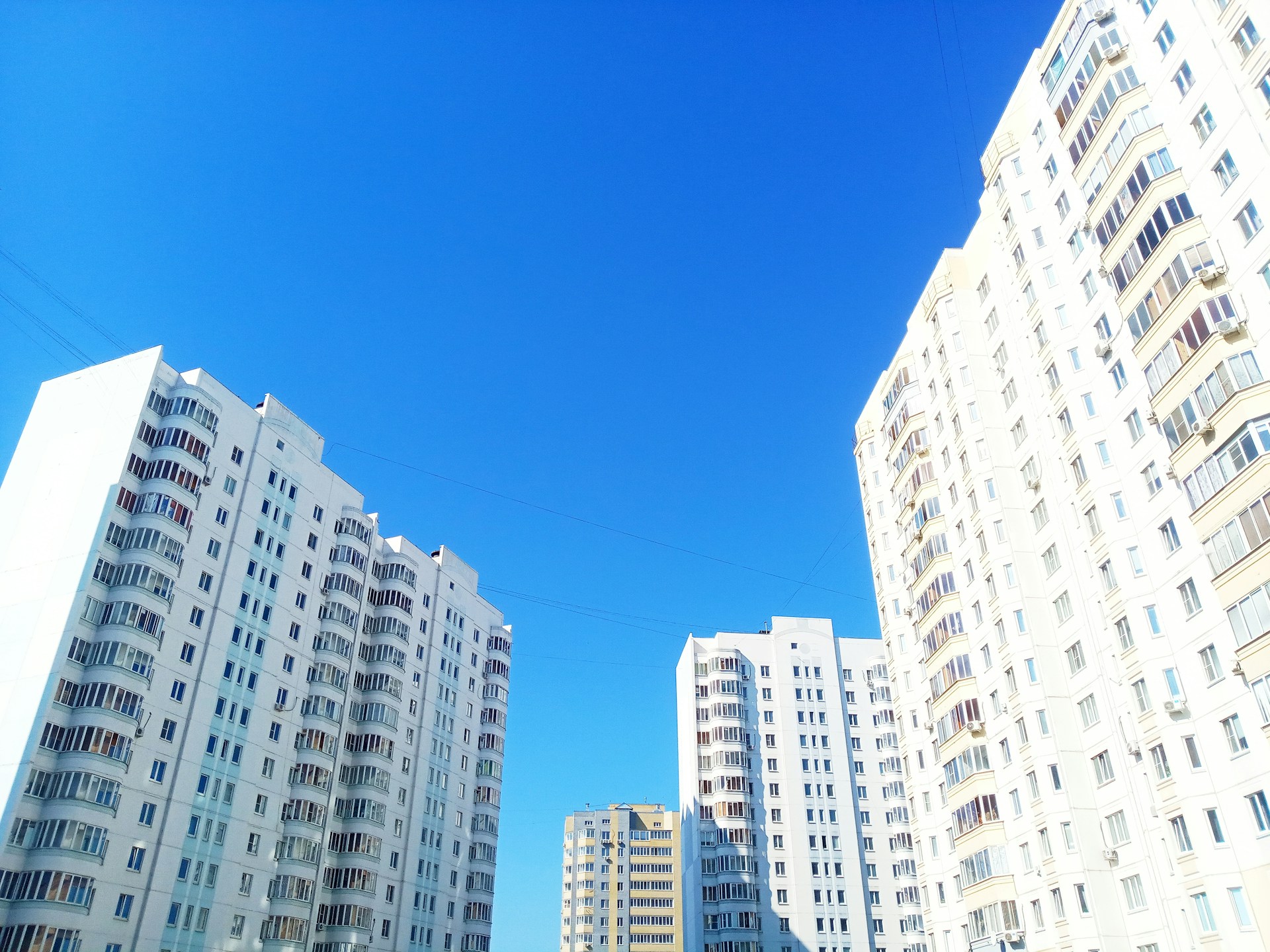 woman wearing yellow long-sleeved dress under white clouds and blue sky during daytime
