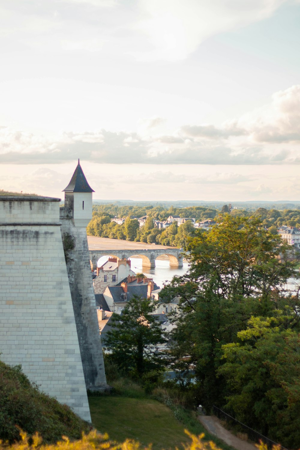 a castle on a hill overlooking a river