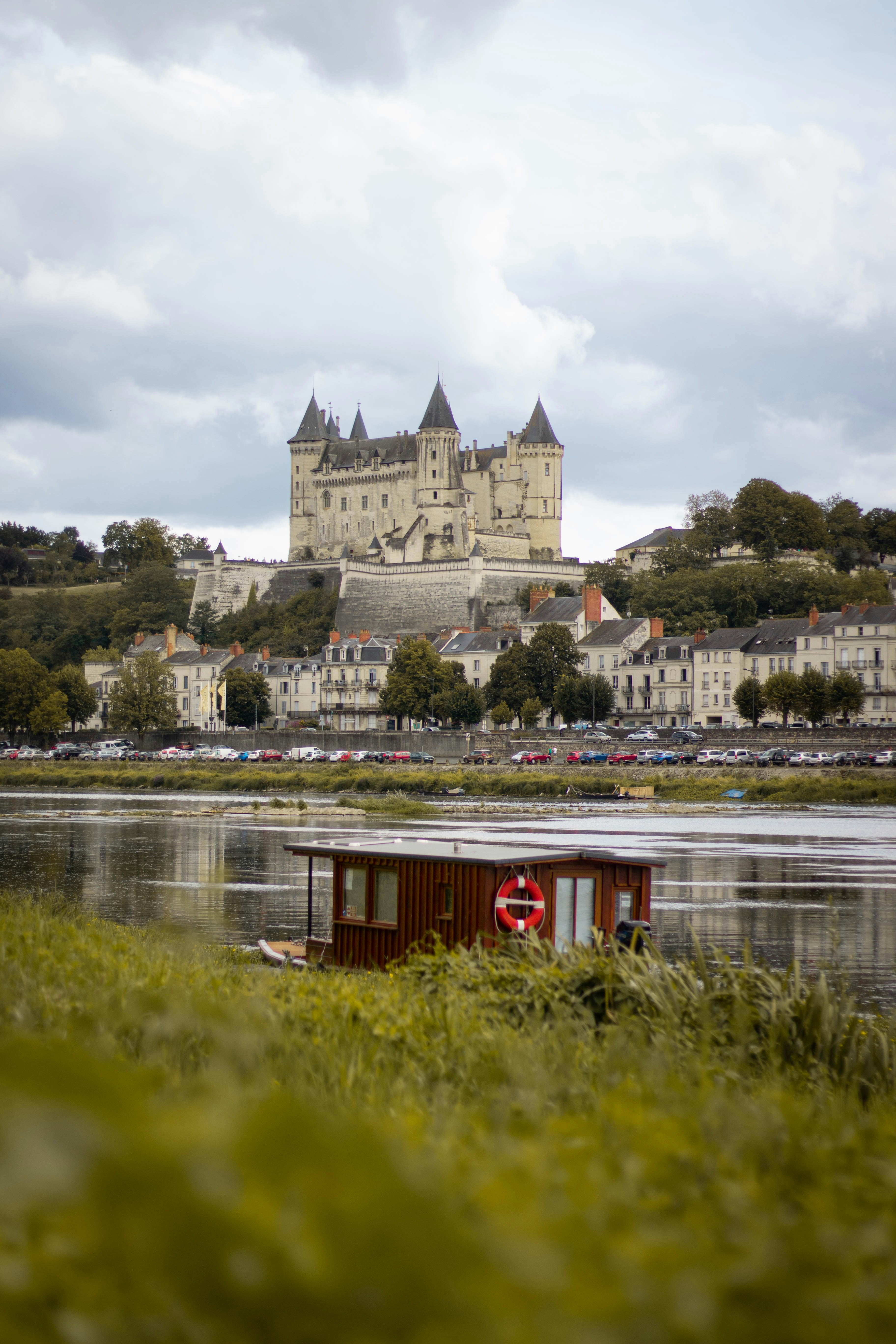 a small boat in a body of water near a castle