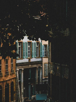 A shadowy, atmospheric image of a classic Italian city street at dusk, hinting at mafia stories.