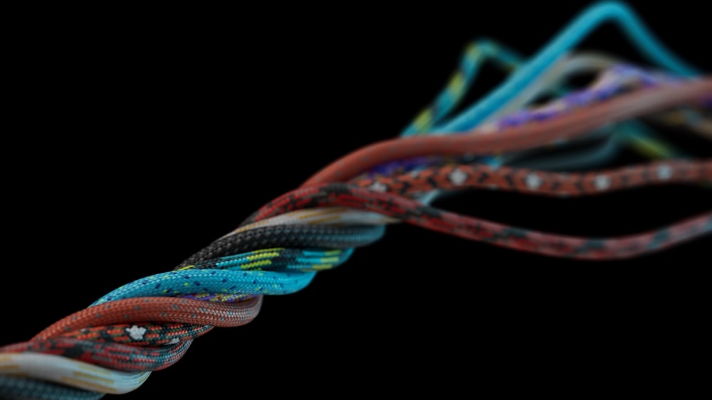 a close up of a multicolored rope on a black background
