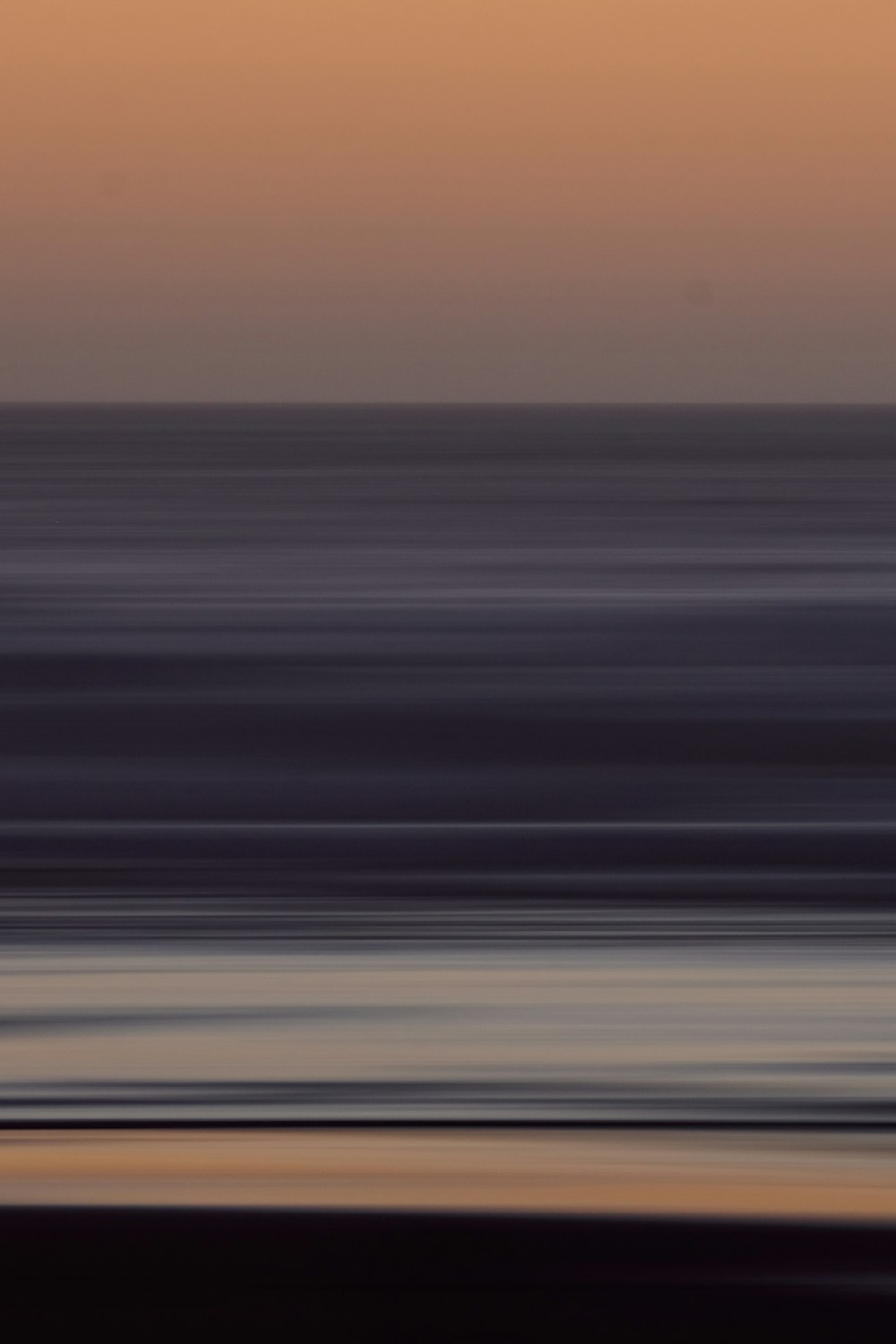 a blurry photo of the ocean at sunset
